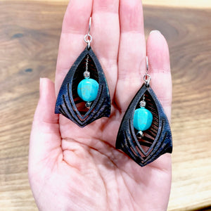 black leather cage earrings with howlite stone in hand